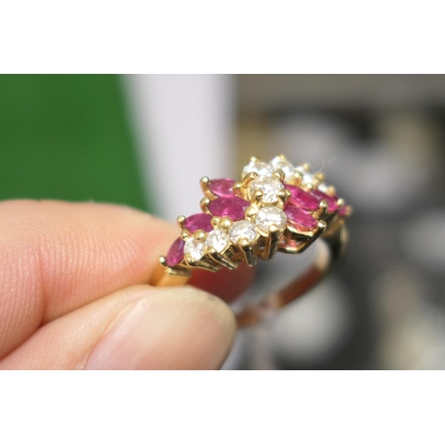 102 - Diamond and marquise ruby cluster ring, centred with nine brilliant cut diamonds totalling approx. 0... 