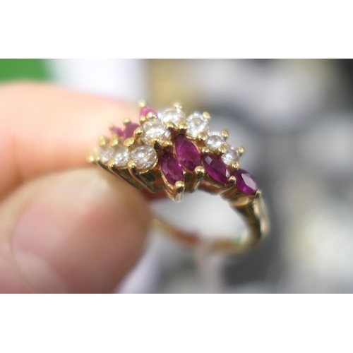 102 - Diamond and marquise ruby cluster ring, centred with nine brilliant cut diamonds totalling approx. 0... 