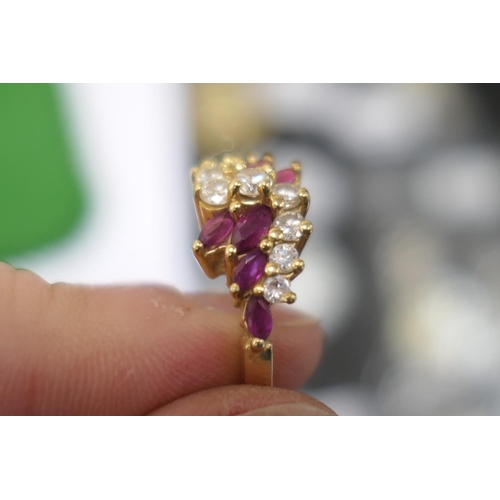 102 - Diamond and marquise ruby cluster ring, centred with nine brilliant cut diamonds totalling approx. 0... 