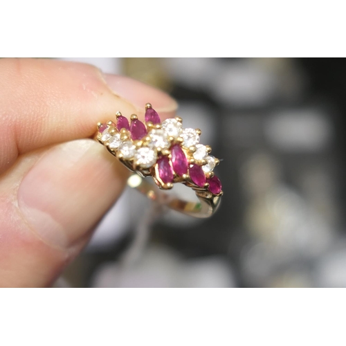 102 - Diamond and marquise ruby cluster ring, centred with nine brilliant cut diamonds totalling approx. 0... 