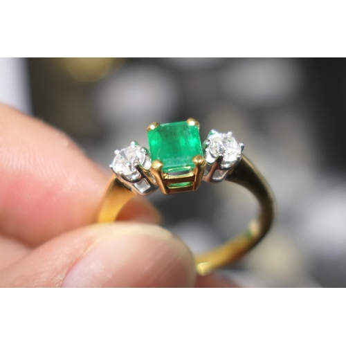 111 - Emerald and diamond three stone ring, the untested emerald of approx. 1ct, in a four claw mount, fla... 