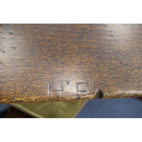 556 - Oak refectory table, Mid 17th Century and later, three plank top patinated and with some old graffit... 