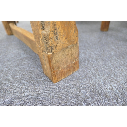 556 - Oak refectory table, Mid 17th Century and later, three plank top patinated and with some old graffit... 