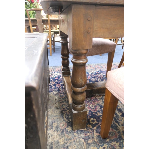 554 - Oak refectory table in 17th Century style, two plank top over turned baluster legs, united by an H-s... 