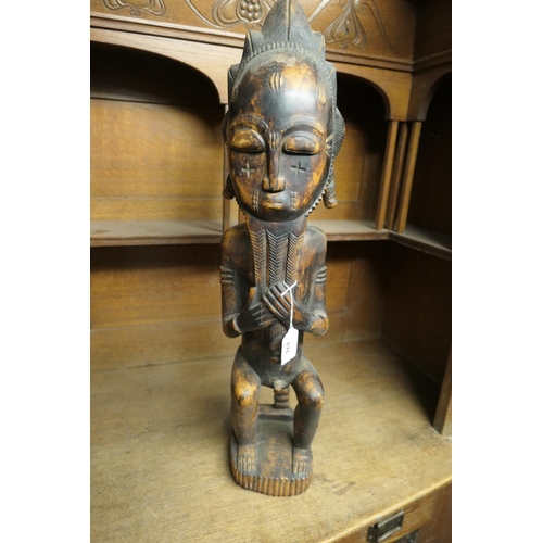 676 - Baule (Ivory Coast) style carved wooden male figure, seated, height 68cm