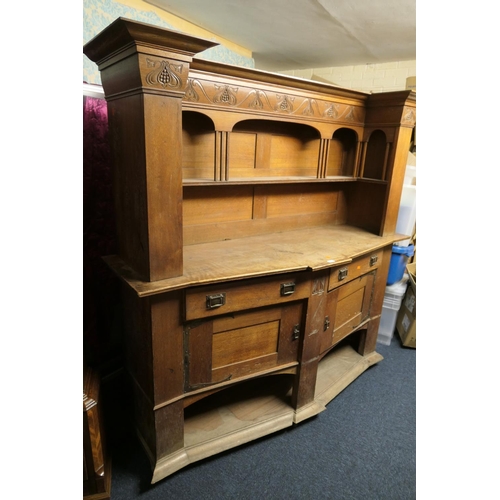 678 - Late Victorian oak sideboard in the manner of Liberty, circa 1900, bow front and with shelf back, de... 