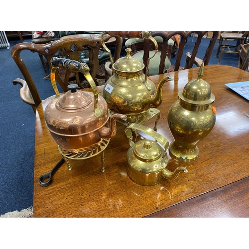 599 - Two brass kettles, copper kettle, two brass trivets, brass lidded vase and an ornamental chestnut ro... 