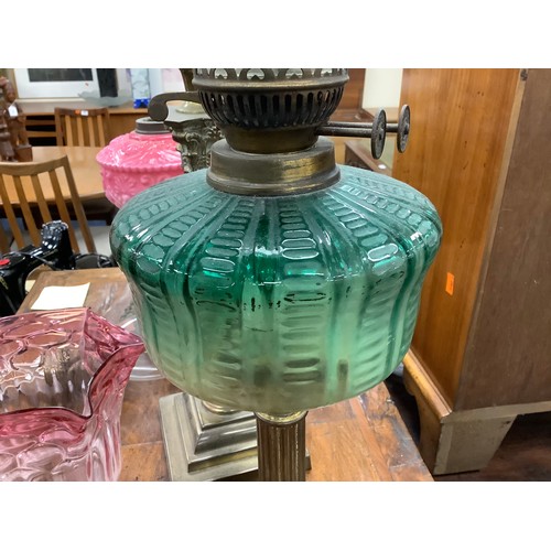 483 - Victorian cast iron and pink moulded glass pedestal oil lamp, also a brass Corinthian column oil lam... 