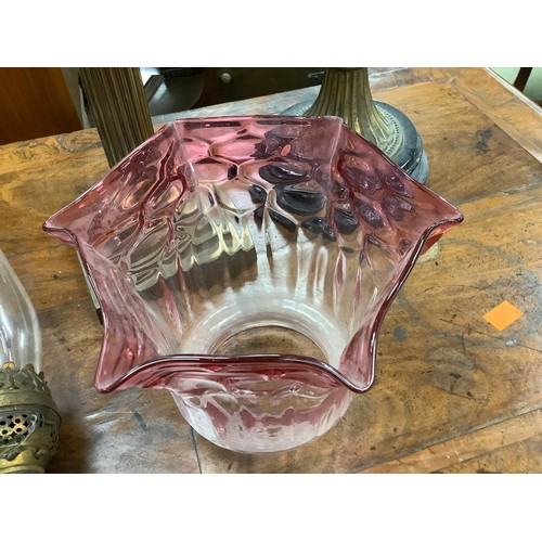 483 - Victorian cast iron and pink moulded glass pedestal oil lamp, also a brass Corinthian column oil lam... 