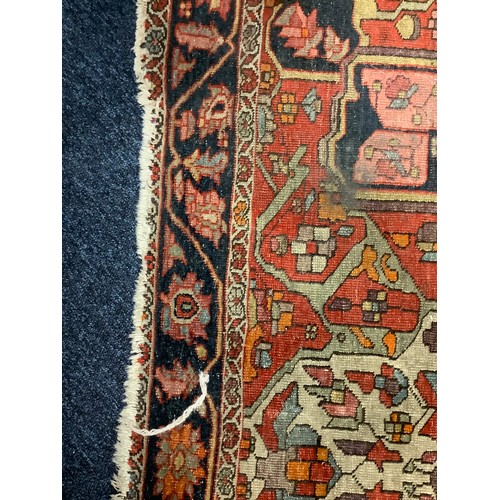 381 - Hamadan red and fawn ground woollen rug, circa 1900, 200cm x 134cm