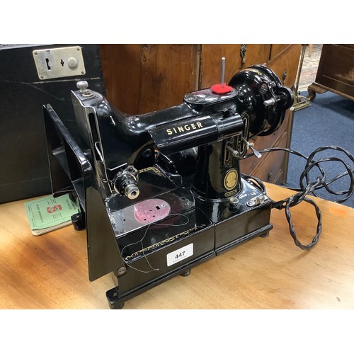 447 - Singer portable electric sewing machine, number 221K, with carrying case, foot pedal and instruction... 