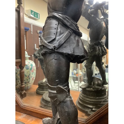 299 - Pair of French spelter figures of fighting knights, with turned wooden bases, height 73cm