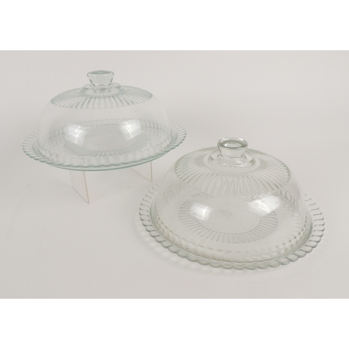 23 - Pair of moulded glass cake bells, the bases 33cm diameter