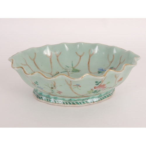 31 - Chinese celadon dish, late 19th Century, detailed as a lotus leaf with famille rose details, printed... 