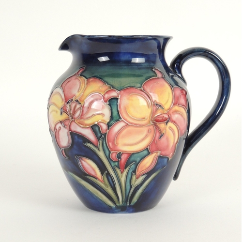 39 - Moorcroft lily pattern blue ground jug, painted signature mark, 16.5cm