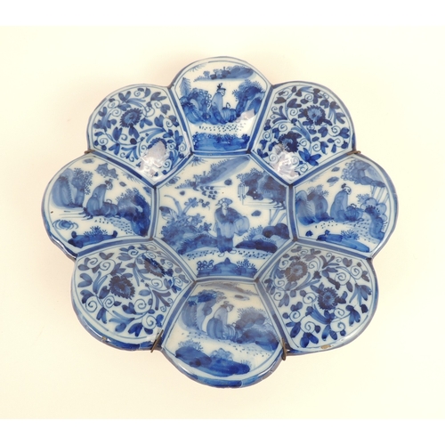 7 - Dutch delft lobed dish, circa 1740, decorated with panels of figures in formalised foliate panels, o... 