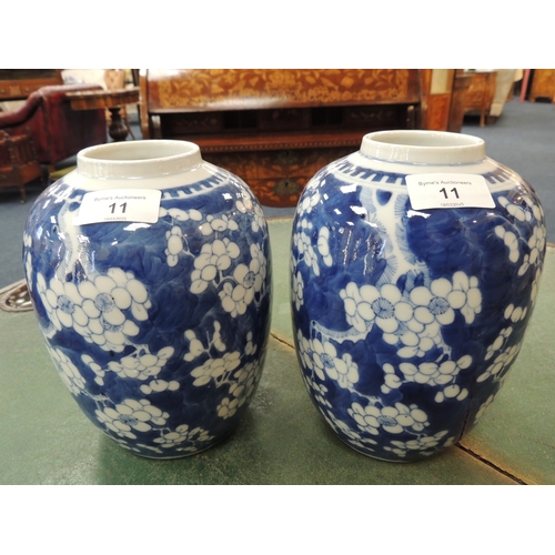 11 - Pair of Chinese blue and white prunus pattern ovoid jars, late 19th Century, painted four character ... 