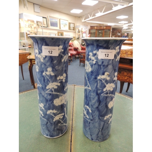 12 - Pair of Chinese blue and white prunus pattern cylinder vases, late 19th Century, four character Kang... 