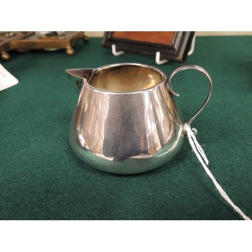 407 - George V silver cream jug, in the style of Dr. Christopher Dresser, Chester 1912, height 6cm, weight... 