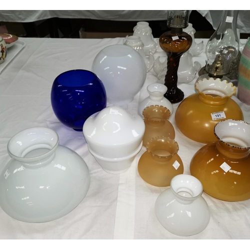 191 - Two glass oil lamps and a selection of glass oil lamp shades and other glass shades