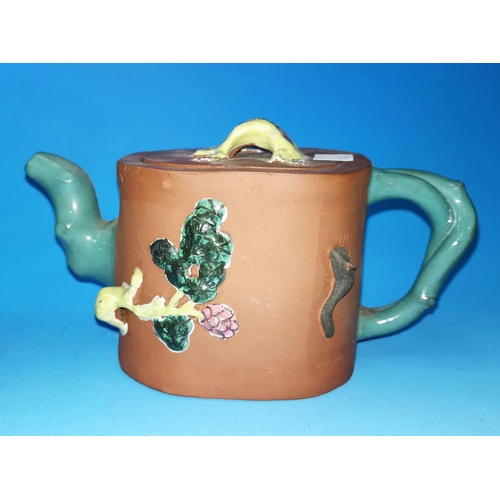 194 - An early 20th century Chinese terracotta teapot with glazed handle, spout and mounts, seal mark to b... 
