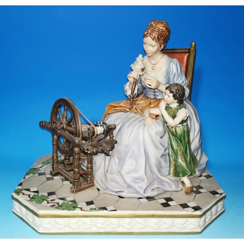 211 - A Capodimonte group: lady with child and spinning wheel, length 12