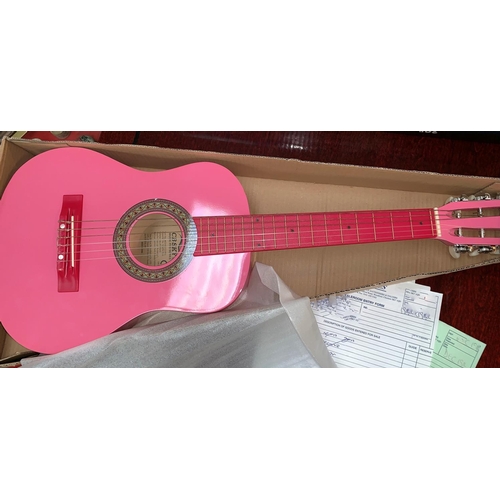 704 - A boxed CB Sky child's classical guitar in pink