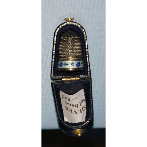 24 - A cased silver thimble with enamel band