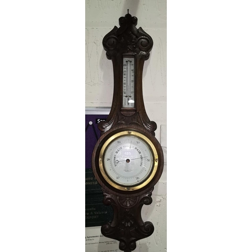 479 - A Jacobean style carved oak cased barometer by Lloyd Payne & Amil of Manchester; A three branch bras... 