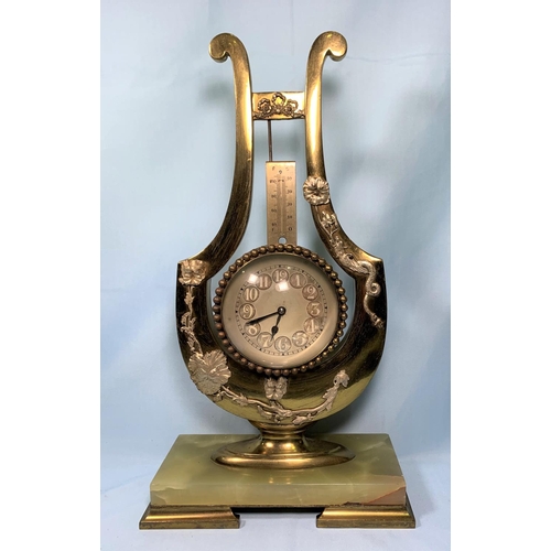 482 - An early/mid 20th century brass lyre shaped mantle clock with applied silvered metal decoration and ... 