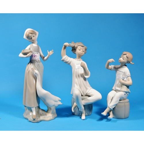 228 - Three Lladro figures:  girl with doll; boy with brush (no mirror); girl feeding goose (finger a.f.)