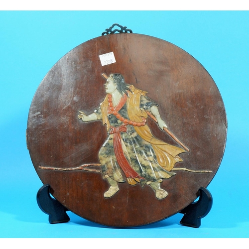 237b - A Chinese circular wooden panel decorated with a warrior in multicoloured stone, diameter 10