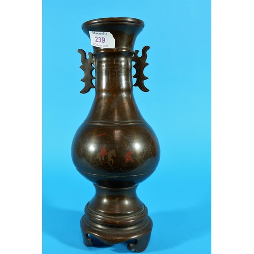 239 - A 19th century Chines bronze baluster vase with 2 shaped handles inlaid with silver and red lacquer ... 
