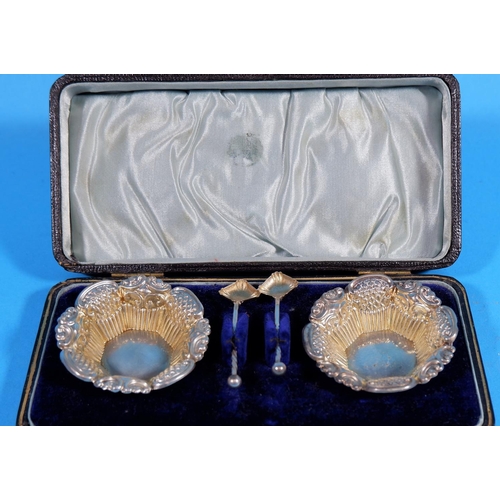 307 - A late Victorian pair of silver salts of hexagonal form, with embossed decoration, matching spoons, ... 