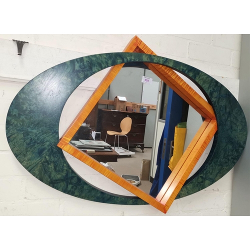 559 - A modernist design wall mirror in shaped twin frame