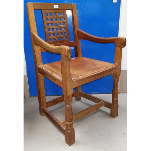 590 - A carver chair by 'Mouseman' Thompson of Kilburn, with woven lattice back, studded leather seat and ... 