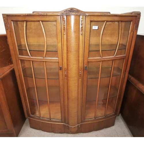 510 - A 130's oak china cabinet enclosed by 2 glass doors