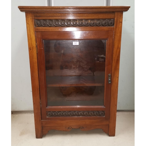 542 - An Edwardian mahogany side cabinet with carved decoration and single glazed door