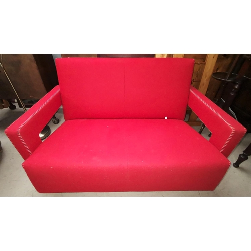 557 - A Cassina two seater settee in red fabric with stitchwork to the arms, designed by Gerrit Thomas Rie... 