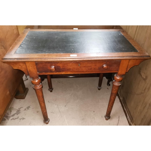 560 - An Edwardian mahogany writing table with drawer, on turned legs