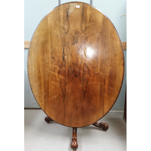596 - A Victorian rosewood oval looe table on turned baluster column and 4 scrolled splay feet and castors... 