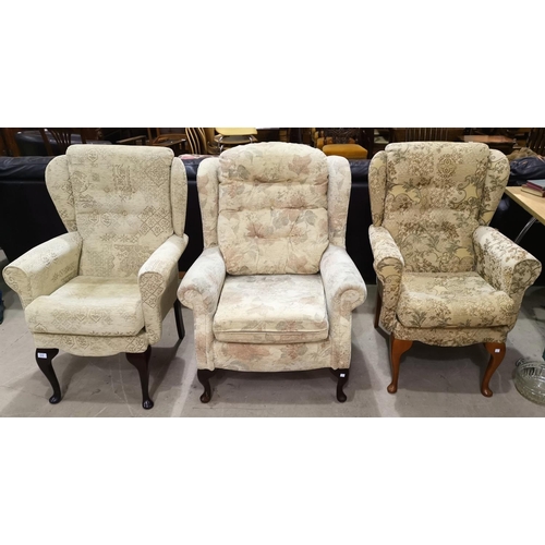 578 - A modern wing back armchair in patterned cream fabric; 2 similar armchairs
