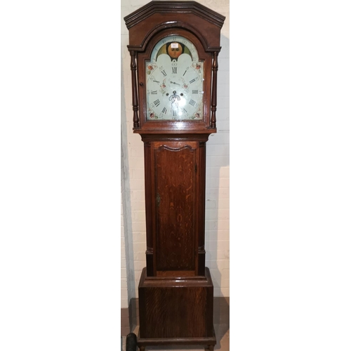 583 - An 18th century longcase clock in crossbanded oak, the hood with moulded cornice and turned columns,... 