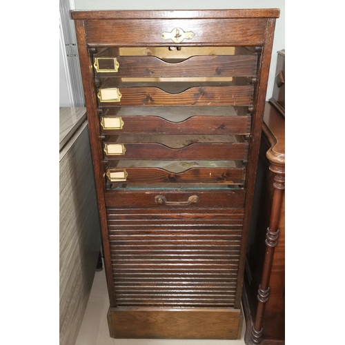 643 - A 1930's oak roll down stationary cabinet