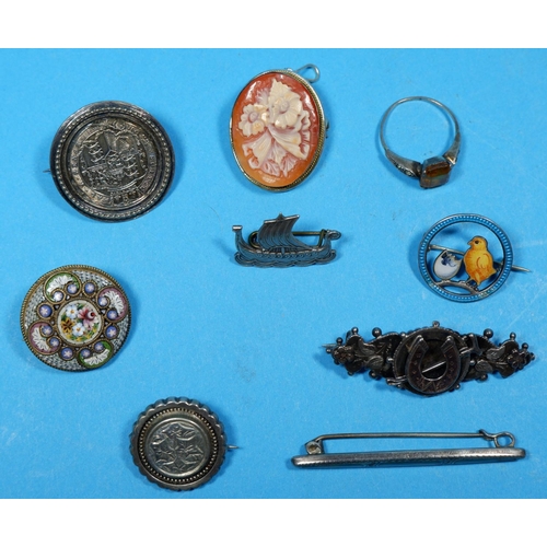 326 - A continental enamelled chick brooch; a Georgian shilling brooch; and others