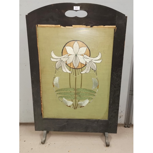 425 - An Art Nouveau embroidered panel depicting lilies set in fire screen, panel height 26.5