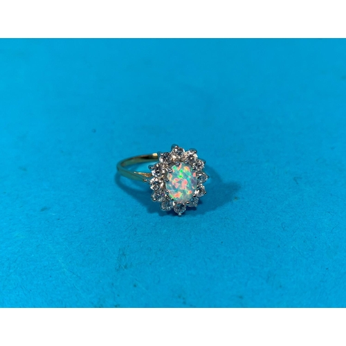 323E - A 9 carat hallmarked gold opal and clear stone dress ring 2.6gm