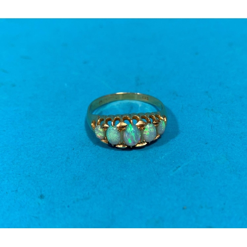 323G - An 18 carat hallmarked gold dress ring set with 5 graduating opals, 3gm