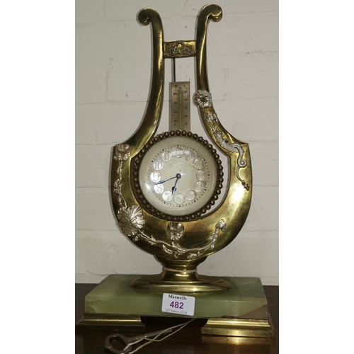 482 - An early/mid 20th century brass lyre shaped mantle clock with applied silvered metal decoration and ... 