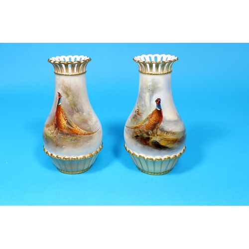 246 - An early 20th century Royal Worcester pair of porcelain vases, with hand painted with polychrome pan... 